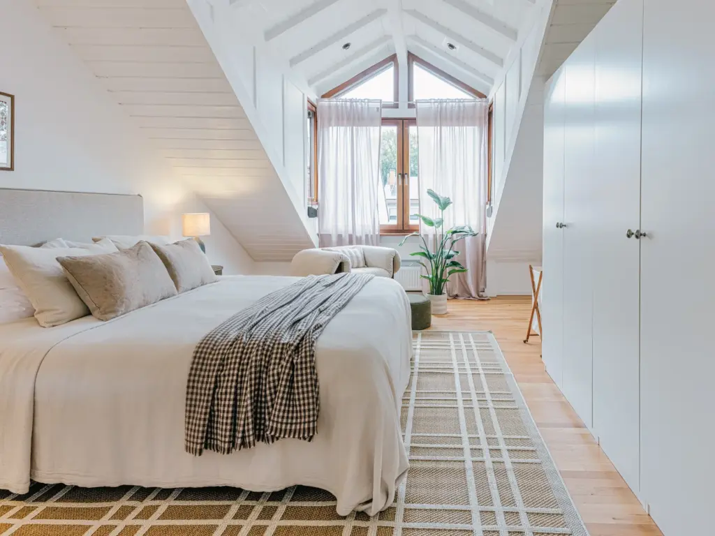 Bright master bedroom with king-size bed and modern decor at Stay Eden TOPAZ BLUE near Ramstein Air Base.