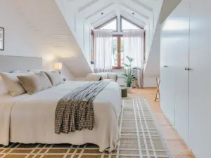 Bright master bedroom with king-size bed and modern decor at Stay Eden TOPAZ BLUE near Ramstein Air Base.