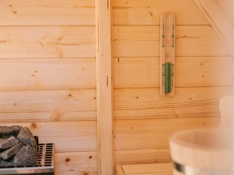 Exclusive Finnish sauna available at the Stay Eden MOONSTONE apartment in Ramstein, featuring wood interiors and a relaxing atmosphere.