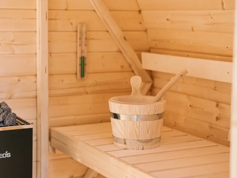 Finnish sauna at the Stay Eden MOONSTONE apartment in Ramstein, designed for relaxation with warm wooden interiors.
