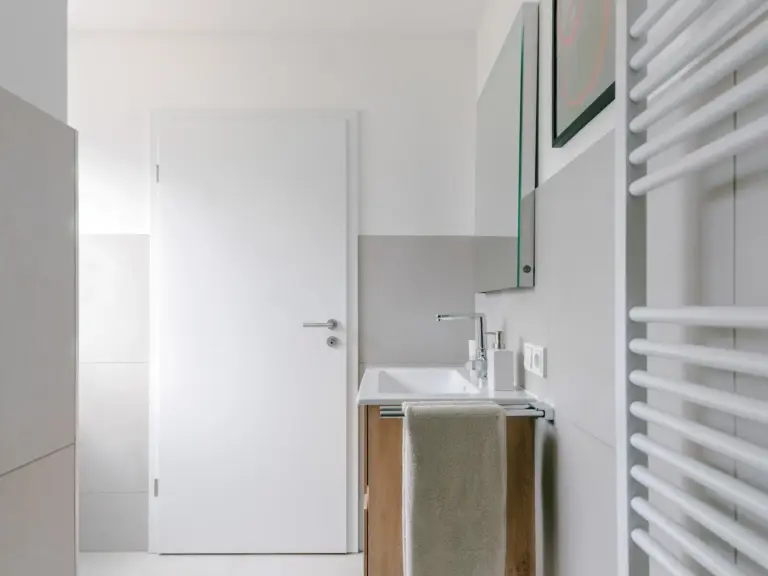Modern bathroom sink with mirror in OPAL GREEN apartment