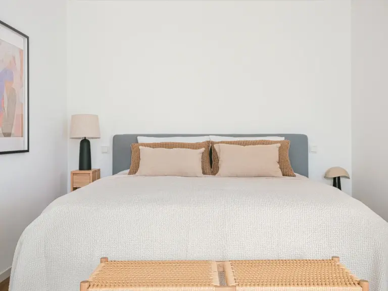 King-size bed with neutral bedding in OPAL GREEN bedroom