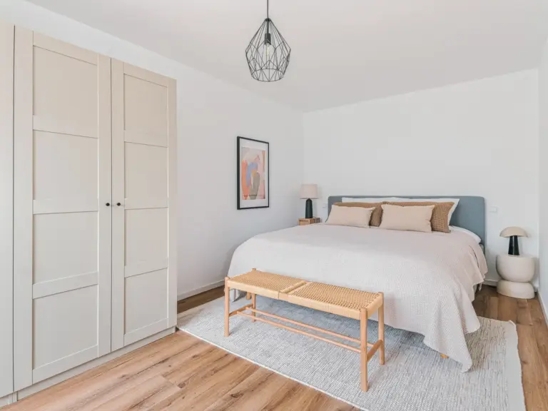 Bedroom with king-size bed and wardrobe in OPAL GREEN apartment