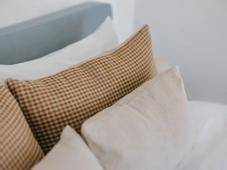 Decorative pillows on king-size bed in OPAL GREEN bedroom