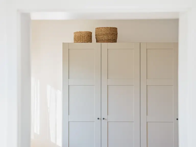 Bedroom wardrobe with woven baskets in OPAL GREEN apartment