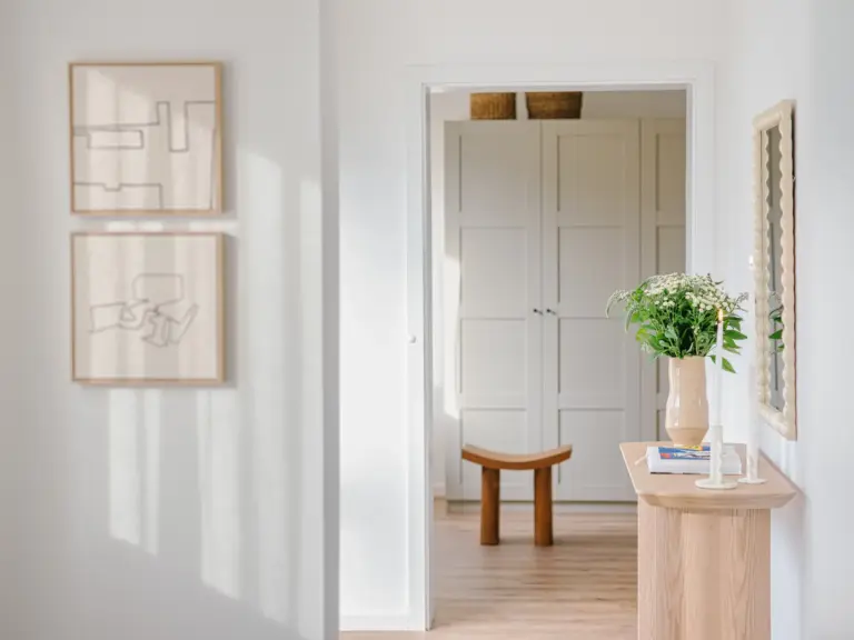 Hallway view toward bedroom with console table in OPAL GREEN apartment
