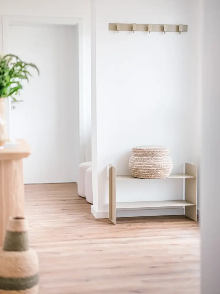 Hallway with coat rack and storage bench in Opal Green apartment