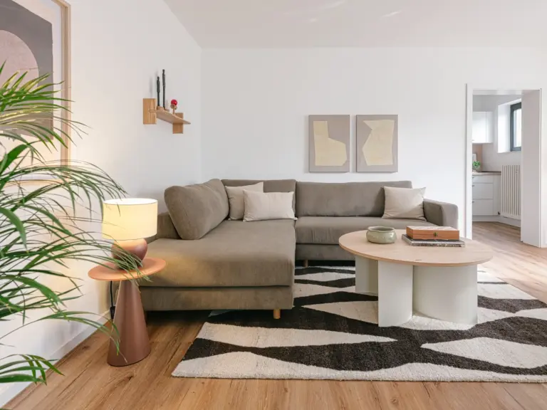 OPAL GREEN TLA apartment living room with modern couch, coffee table and natural tones near Ramstein Air Base