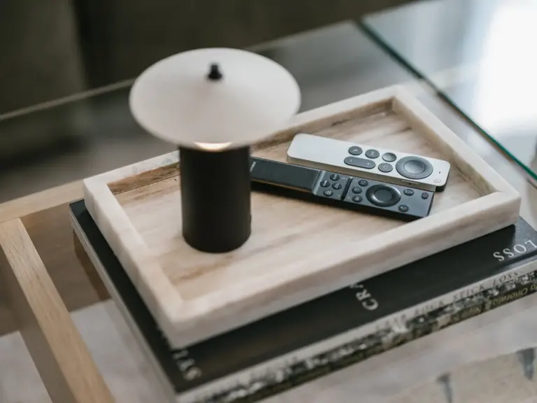 Coffee table detail with remote controls in OPAL BLUE TDY and TLA apartment