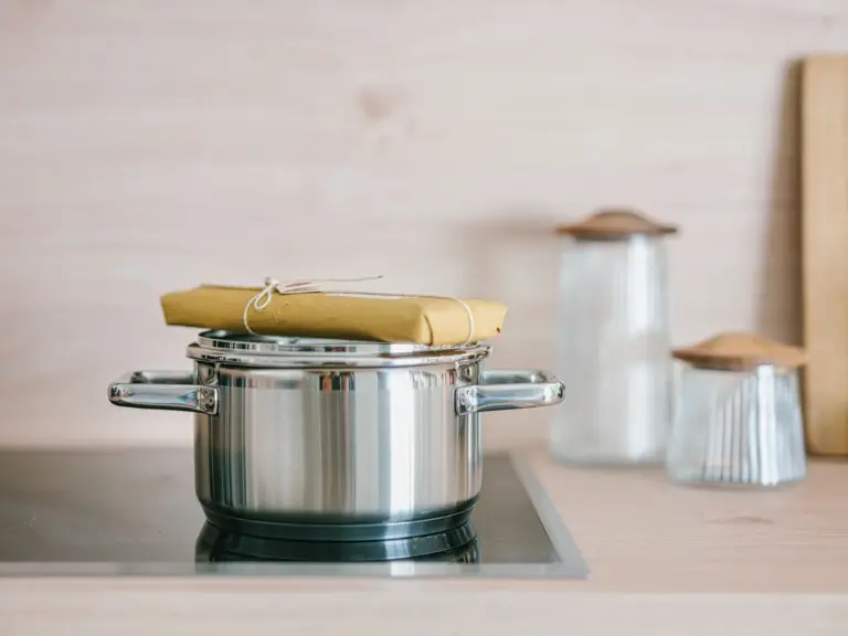 Stainless steel cooking pot on induction stove in OPAL BLUE TLA apartment kitchen