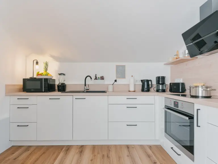 Kitchen counter with appliances in OPAL BLUE TDY and TLA apartment