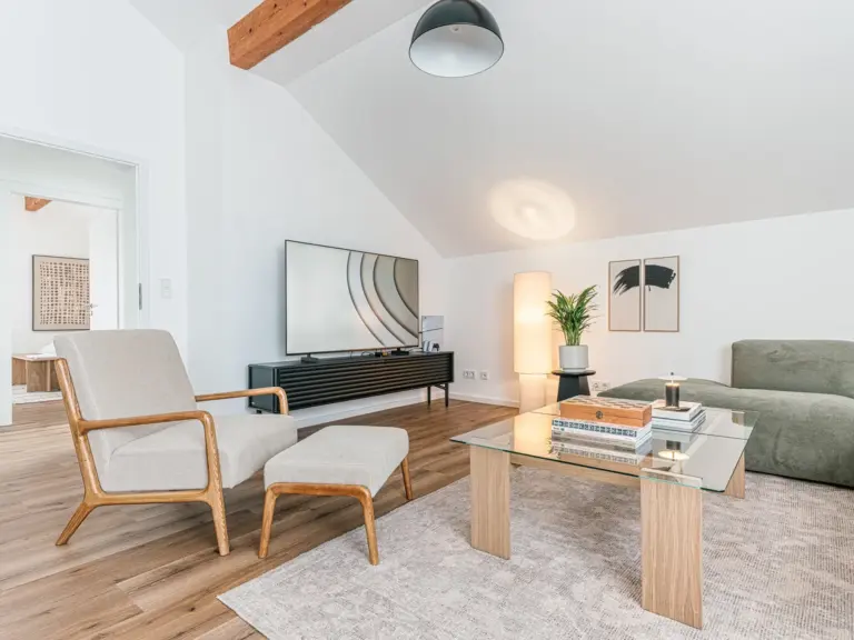Living area with armchair, coffee table and TV in OPAL BLUE TDY and TLA apartment