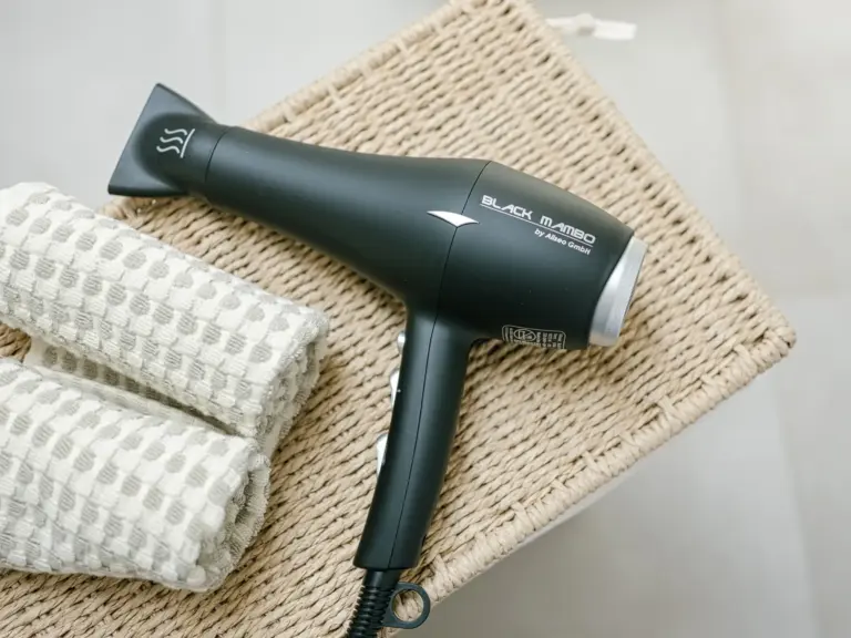 Hairdryer and folded towels in OPAL BLUE main bathroom