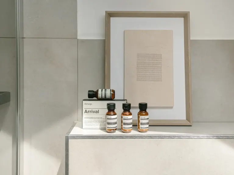 Toiletries and framed artwork in OPAL BLUE second bathroom