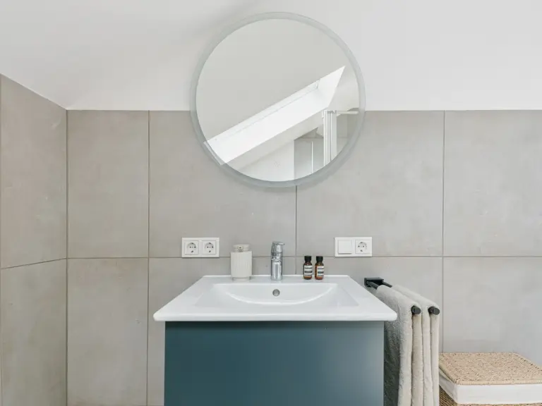 Second bathroom vanity with round mirror in OPAL BLUE