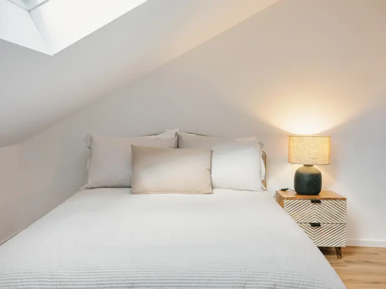 Second bedroom bed with bedside table in OPAL BLUE