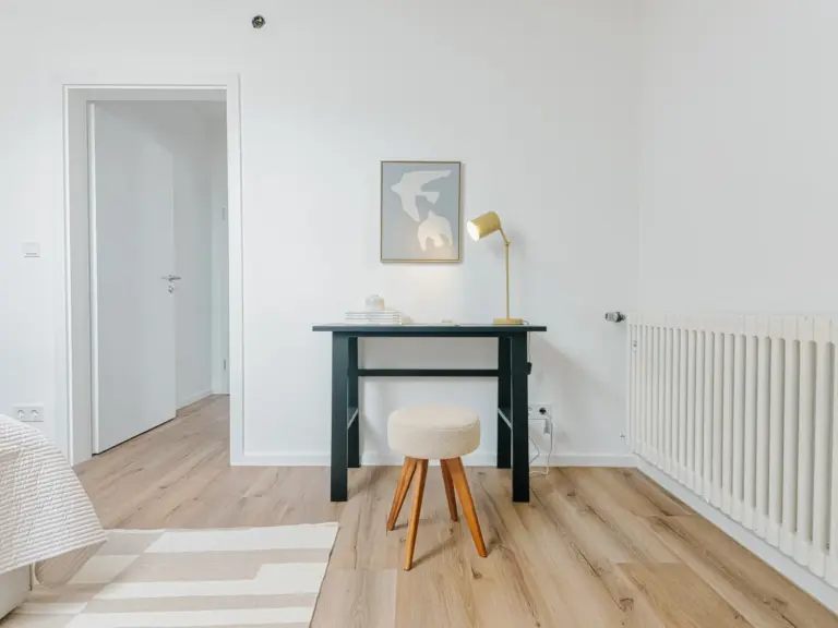 Second bedroom workspace with desk and chair in OPAL BLUE