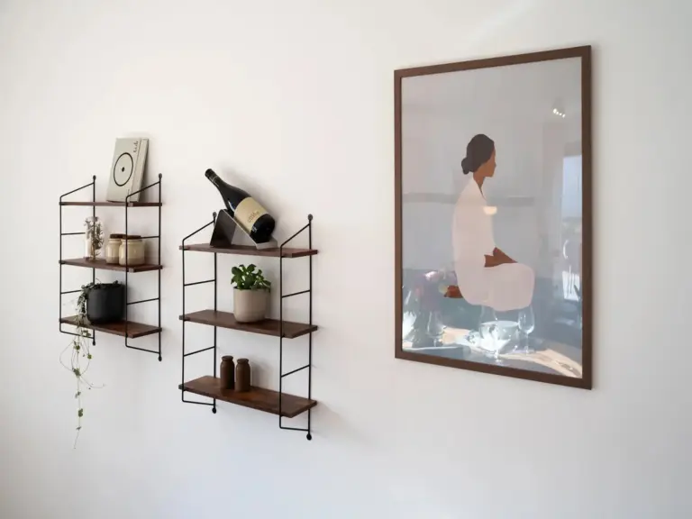 Modern wall shelves with decor and framed artwork in Opal White apartment