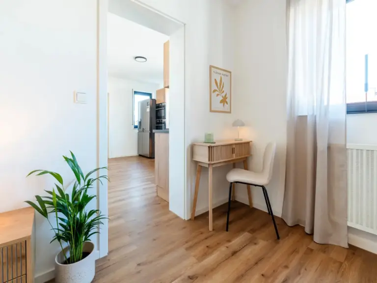 Bedroom workspace with desk and chair in Opal White apartment