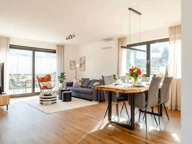 Spacious open living and dining area with terrace access in Opal White apartment