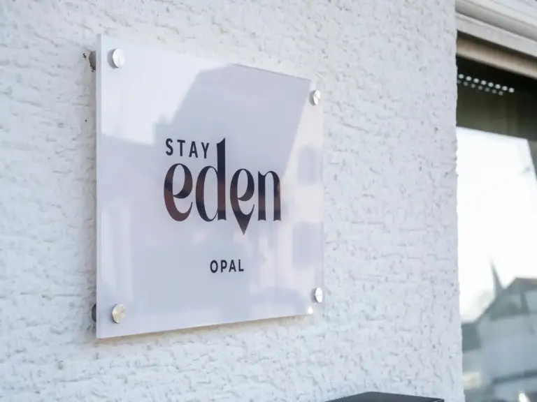 Stay Eden Opal apartment sign mounted on a modern exterior wall
