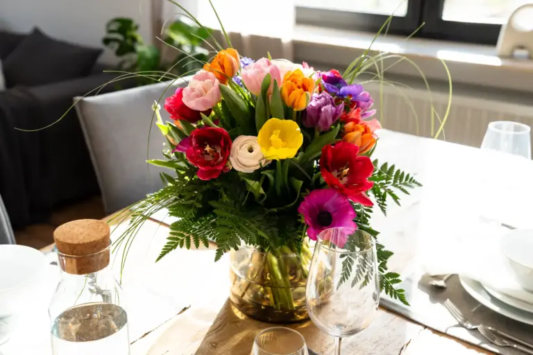 Colorful fresh flower bouquet on a dining table in modern apartment Opal White