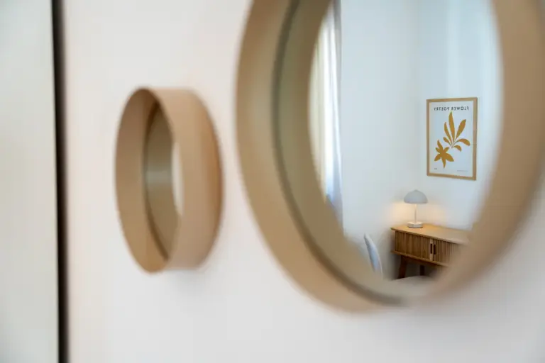 Round mirror reflecting dedicated workspace in modern apartment Opal White