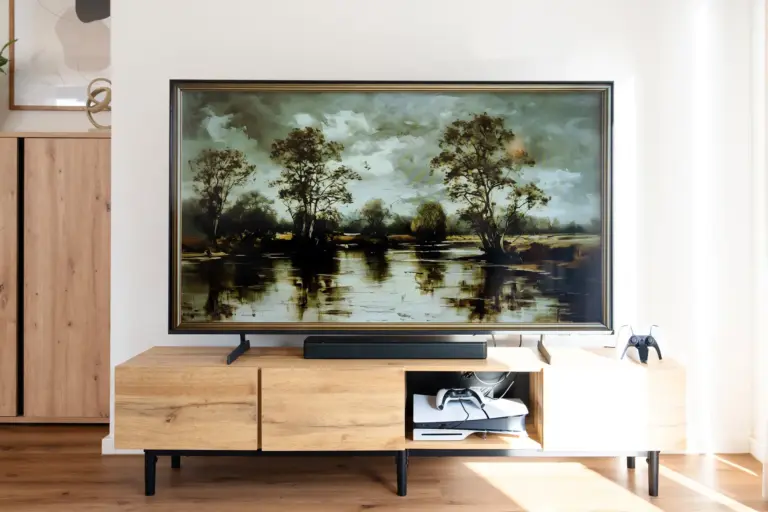Modern 4K Smart TV with entertainment setup on wooden cabinet in living room