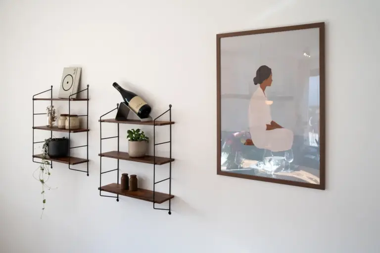 Modern wall shelves with decor and framed artwork in Opal White apartment