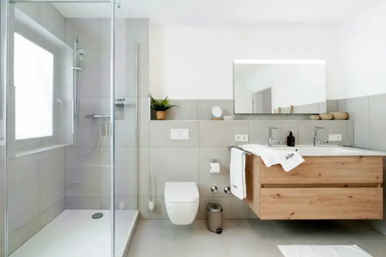 Modern bathroom with walk-in shower and double vanity in Opal White apartment
