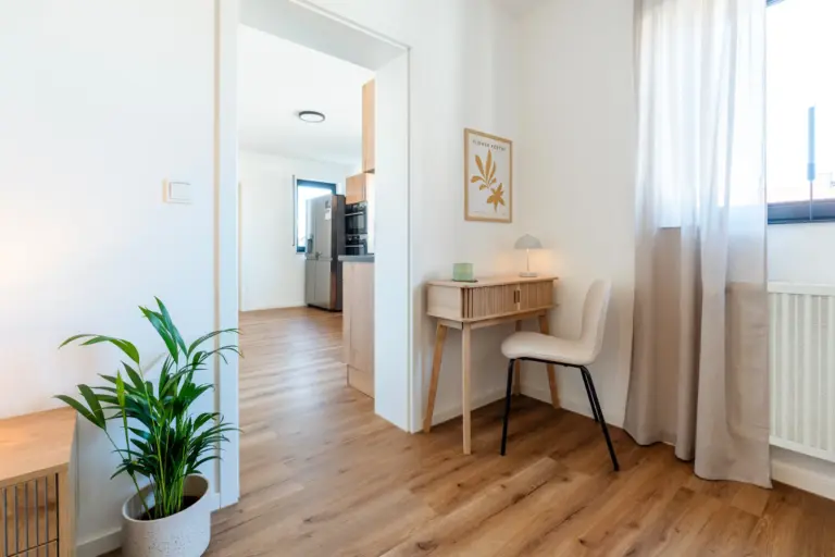 Bedroom workspace with desk and chair in Opal White apartment
