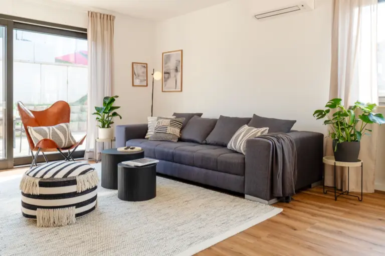 Modern living room with large sofa and terrace access in Opal White apartment