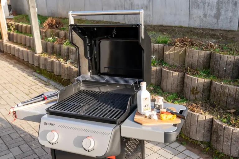 Modern gas grill on outdoor terrace at Opal White apartment