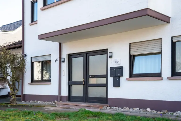Entrance of Stay Eden Opal apartment building with modern facade and front door