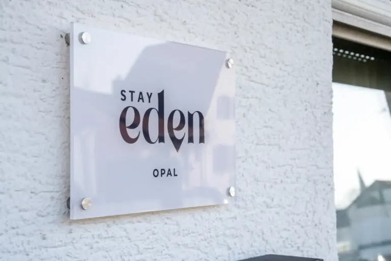 Stay Eden Opal apartment sign mounted on a modern exterior wall
