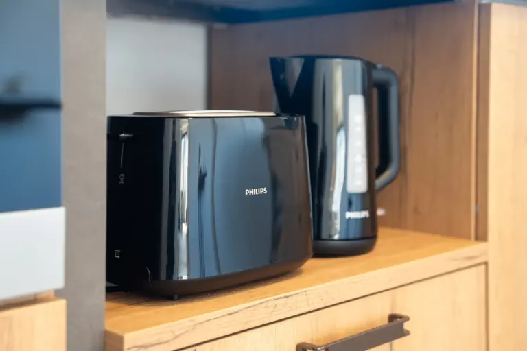 Modern toaster and electric kettle on a wooden shelf in Opal White kitchen