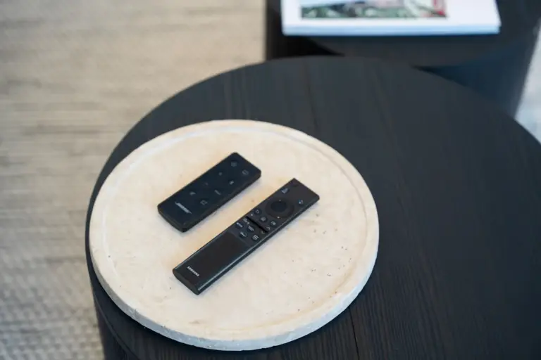 TV remote controls on a modern coffee table