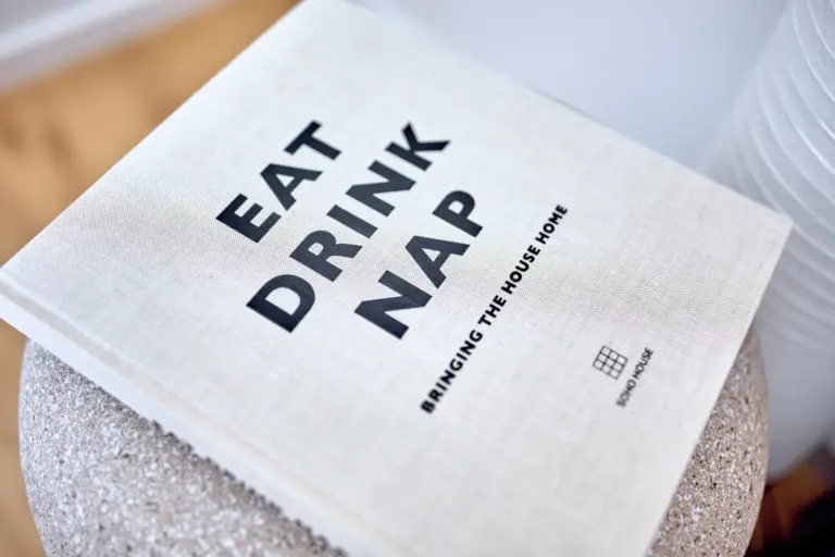 Eat Drink Nap book displayed as a decorative detail in CORAL BLOOM's bedroom