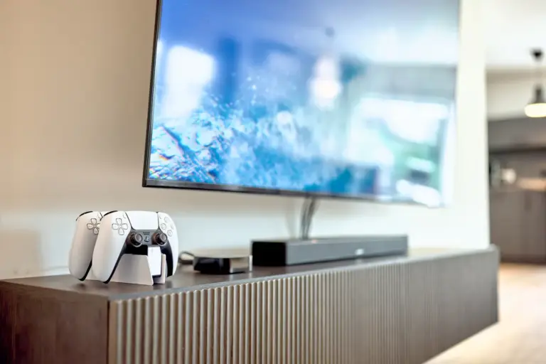 Smart TV with PlayStation 5 controllers, Apple TV and BOSE soundbar at CORAL BLOOM