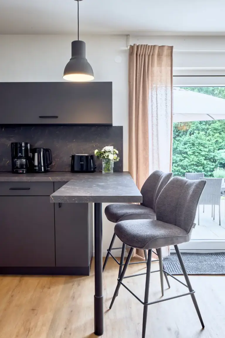 CORAL BLOOM modern kitchen with breakfast bar, bar stools and direct garden access
