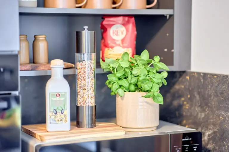 Fresh basil with olive oil and seasoning displayed in the modern kitchen at CORAL BLOOM