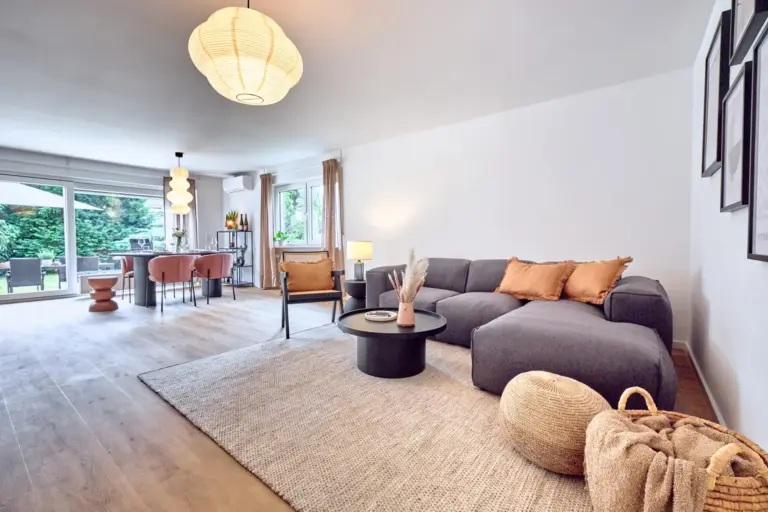 CORAL BLOOM living area with spacious sectional sofa, modern furnishings, dining area and direct garden access
