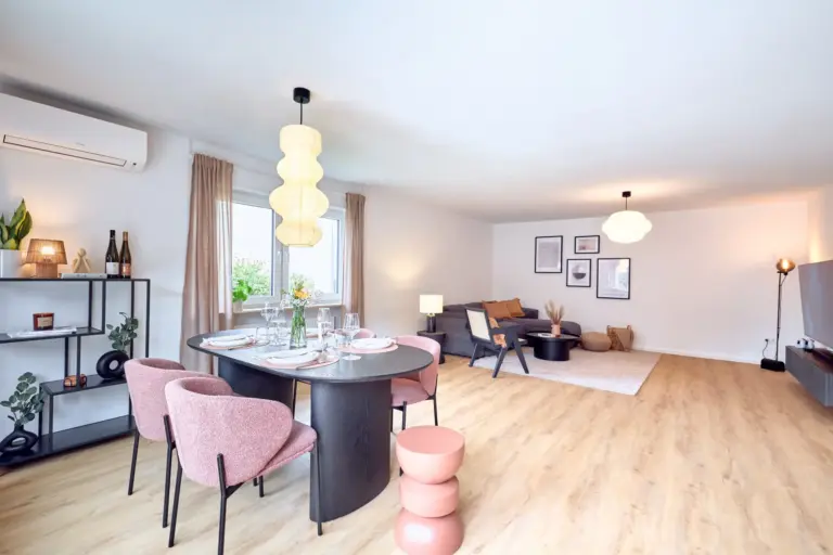 Spacious open-plan living and dining area at CORAL BLOOM with dining table, lounge and entertainment area