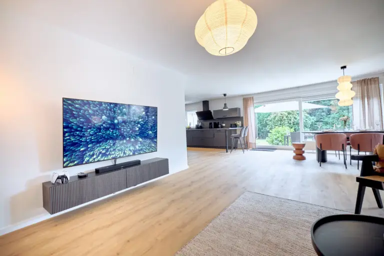 CORAL BLOOM open-plan living space with large Smart TV, modern kitchen, dining area and garden access