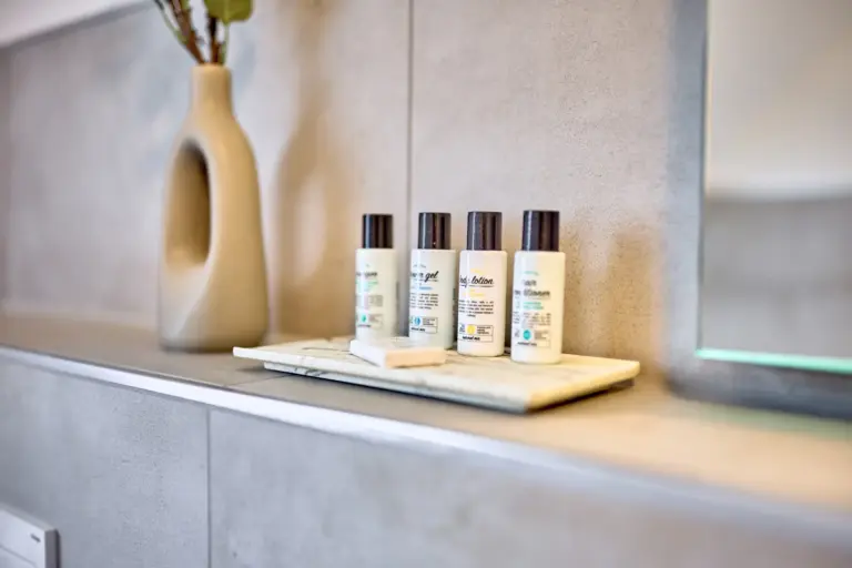 Premium toiletries and soap arranged on a tray in the bathroom at CORAL SUN