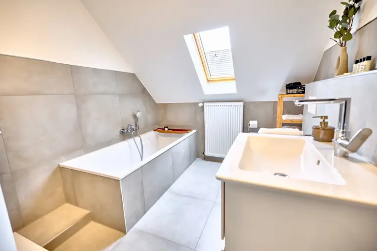 CORAL SUN bathroom with bathtub, shower, vanity and skylight