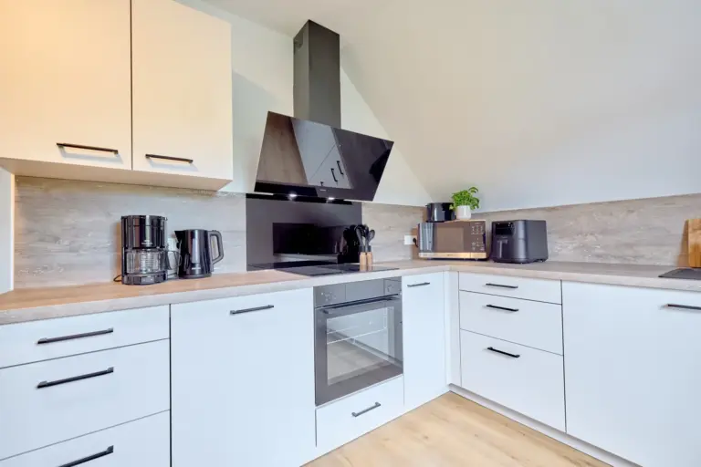 Modern CORAL SUN kitchen with induction cooktop, oven, microwave, air fryer, coffee maker and electric kettle