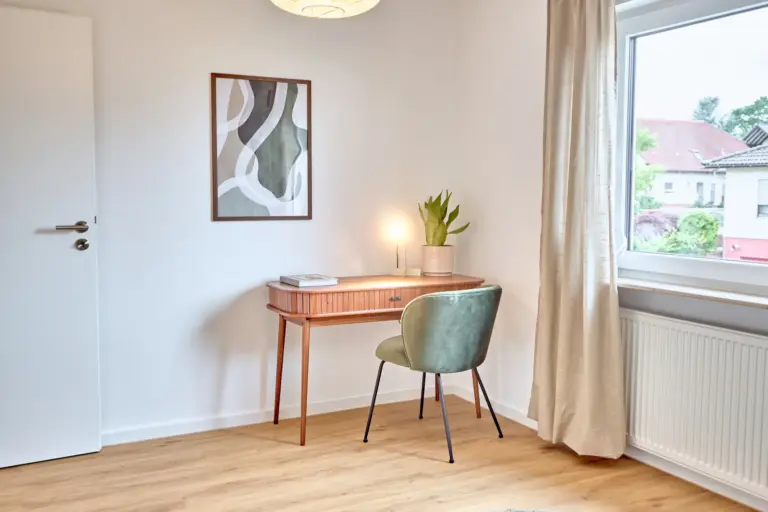 Dedicated workspace with wooden desk and green chair in CORAL SUN