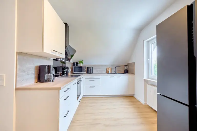 CORAL SUN kitchen with large side-by-side refrigerator and white cabinetry