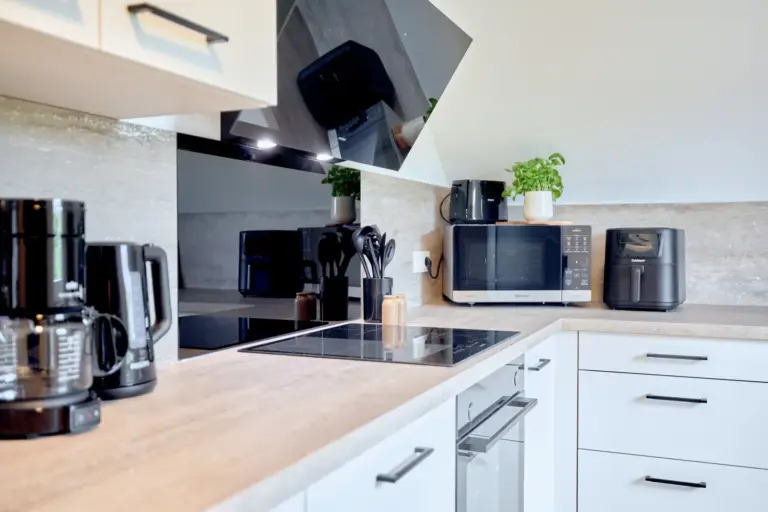 CORAL SUN kitchen with induction cooktop, microwave, air fryer and additional countertop appliances